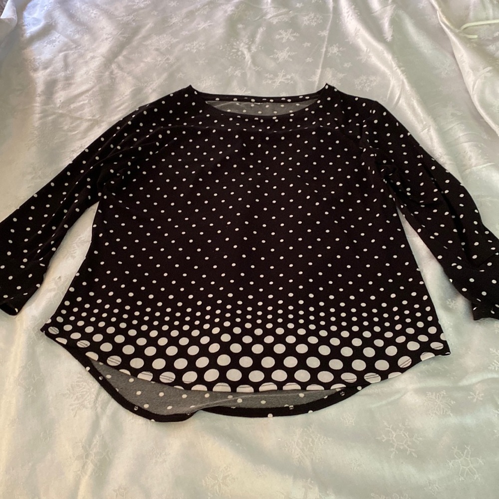 Black top with white polka dots . Slip over your head. Scoop neck. Bell sleeves